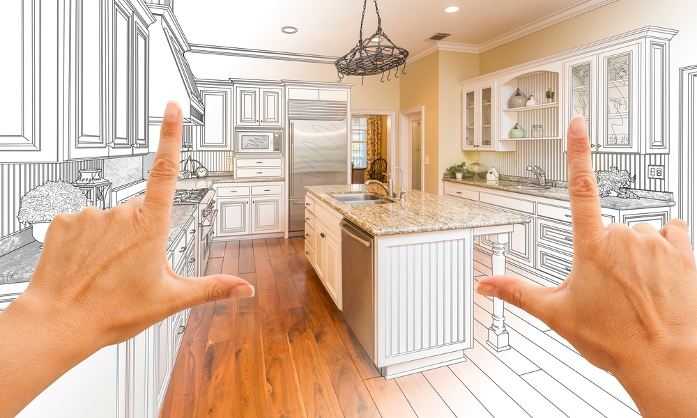A point of view of someone standing in front of a half-finished, half-drawn kitchen with hands framing the space.